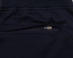 Close-up of a pair of dark navy scrub  pants showing a zippered pocket with a small metallic zipper pull.