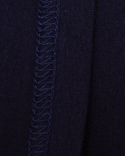 Close-up of the interior of navy knit fabric with flat-stitch hem running vertically down the center.