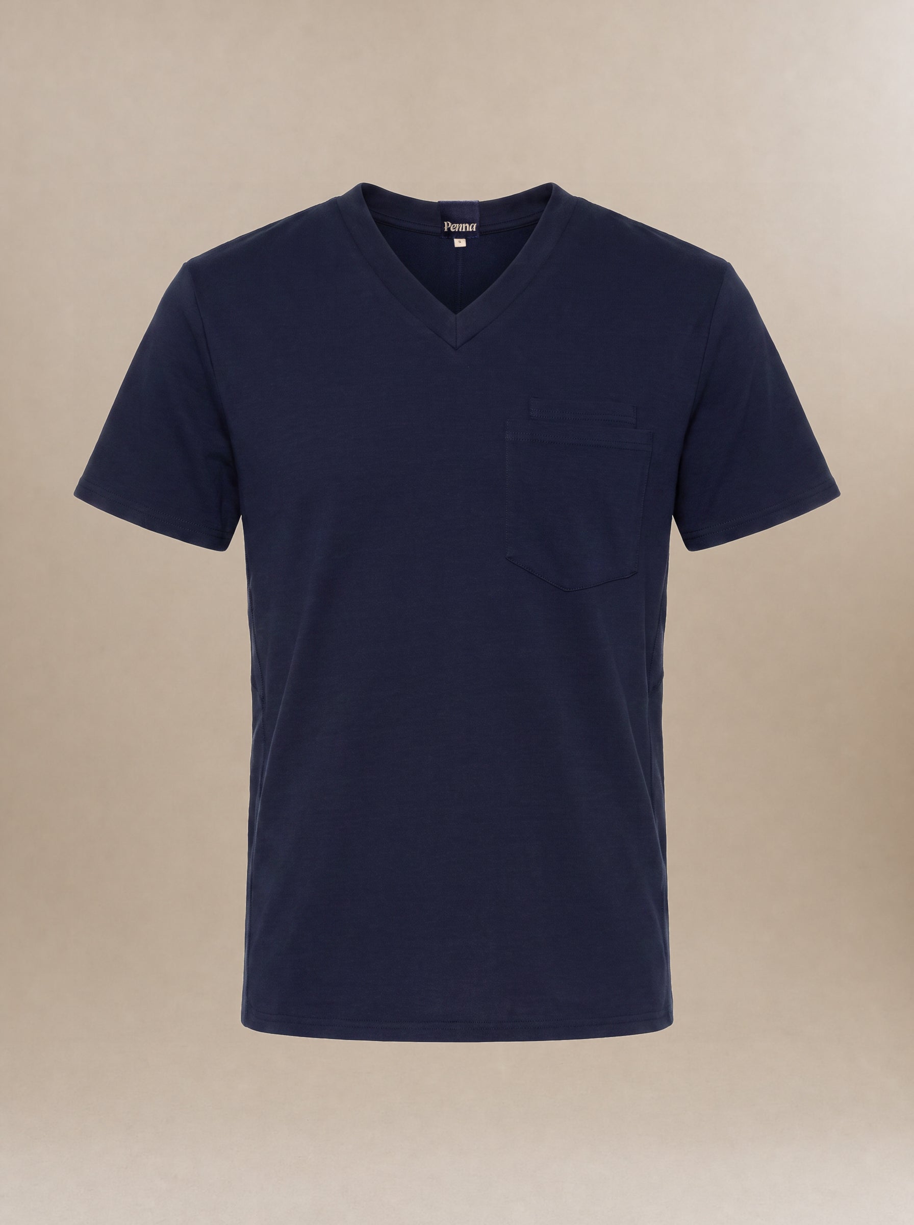 A men's navy blue v-neck short-sleeve scrub top with a pocket on the left chest against a beige background.