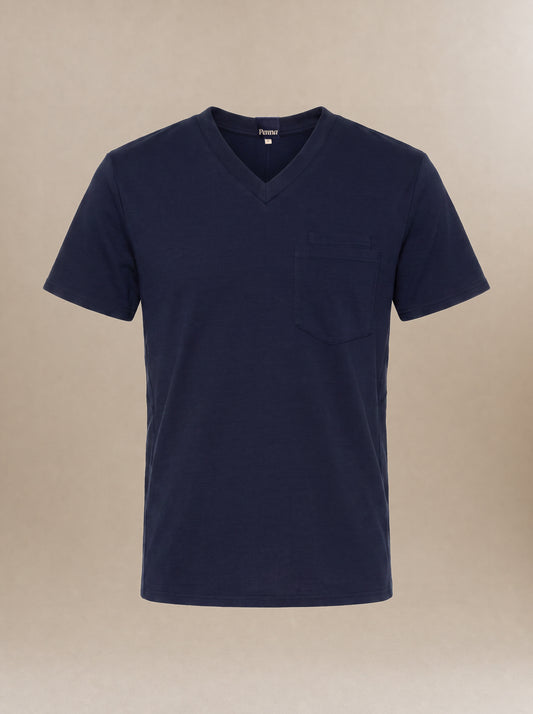 A men's navy blue v-neck short-sleeve scrub top with a pocket on the left chest against a beige background.