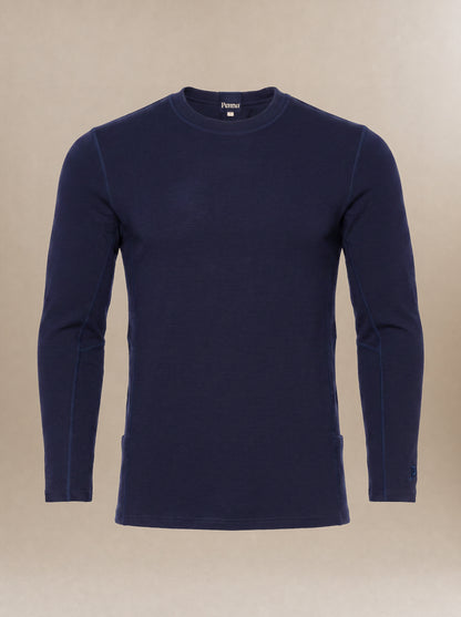 A men's, navy blue long-sleeve crewneck subscrub top displayed on a neutral beige background.