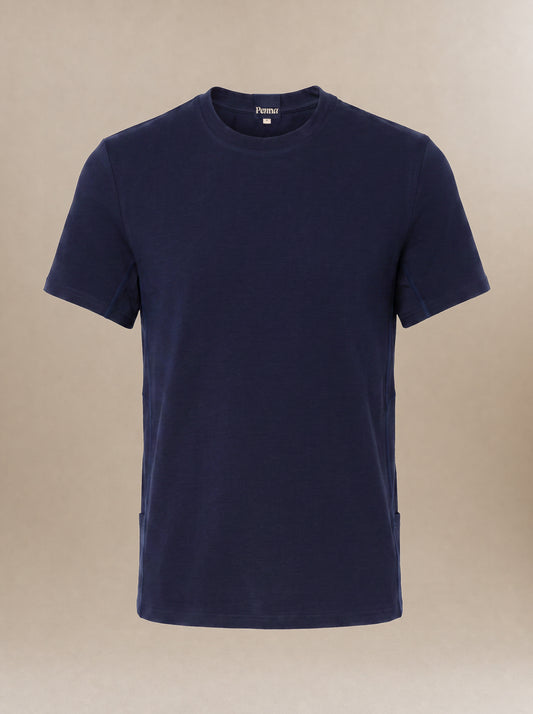 A navy blue short-sleeve crewneck subscrub shirt displayed on a neutral beige background.