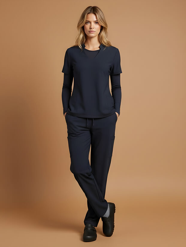 woman wearing navy blue scrubs and black shoes