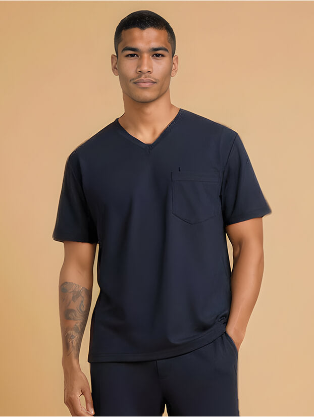 man from the waist up in a short-sleeved navy blue medical scrub top