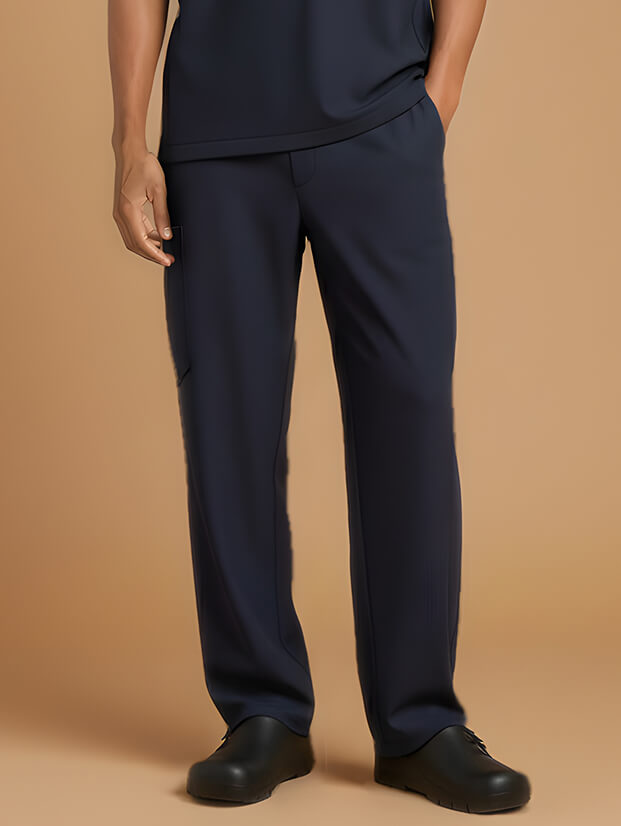 men’s legs in navy blue medical scrubs and black shoes