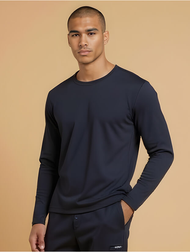 man from the waist up in a long-sleeved navy blue medical scrub top