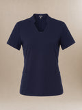 Women's navy blue, short-sleeve, v-neck scrub top on a beige background