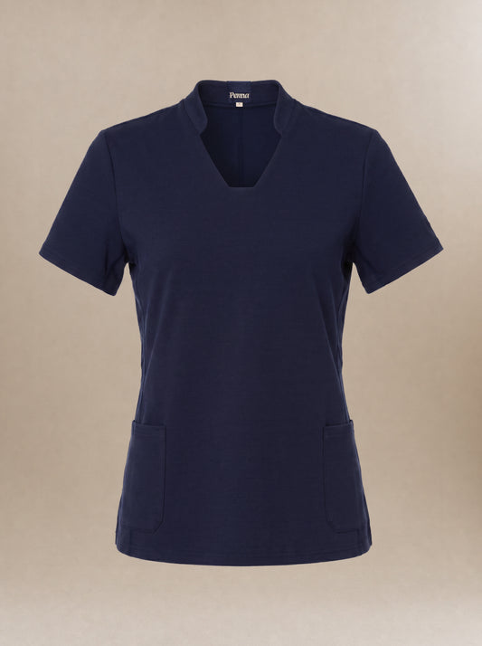 Women's navy blue, short-sleeve, v-neck scrub top on a beige background